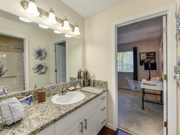 Bathroom with Vanity , Granite Counters and View of Bedroom